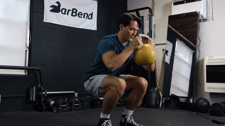 Our tester performing the goblet squat exercise with the Bells of Steel Competition Kettlebell.